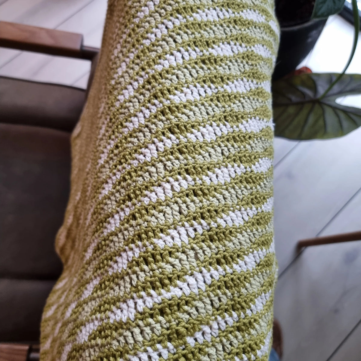 Gehaakt Haakpatroon deken Dee die over een stoel hangt, haakpatroon ontworpen door Cora's Knit Knacks