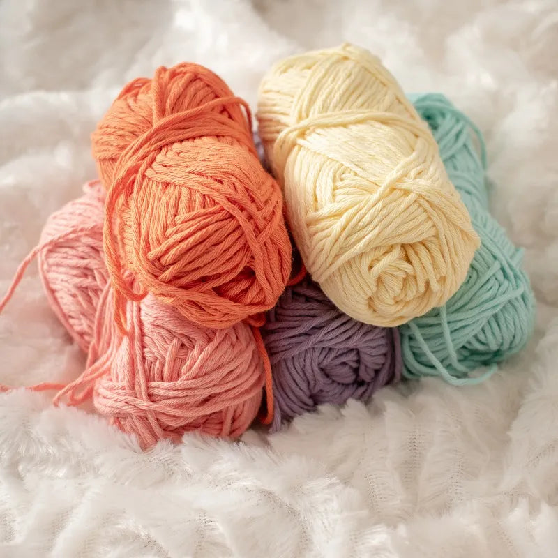Vijf vrolijke lente kleuren van Hoooked Soft Cotton DK bij elkaar op een witte ondergrond