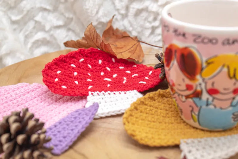 Verschillende gehaakte paddenstoel onderzetters bij elkaar gemaakt met het  Haakpatroon paddenstoel onderzetter Toora ontworpen door Cora's Knit Knacks